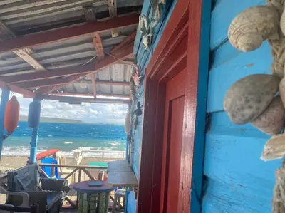 an open door to a room with a view of the ocean at Casa Zanelli, lugar de paz… in Baní