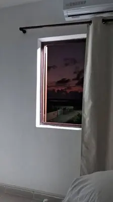 a window in a white room with a sunset at Casa Zanelli, lugar de paz… in Baní
