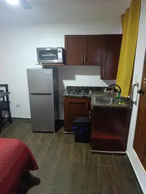 a small kitchen with a sink and a refrigerator at Apart hotel Costa Verde #3 Exclusivo y Seguro in Santa Bárbara de Samaná
