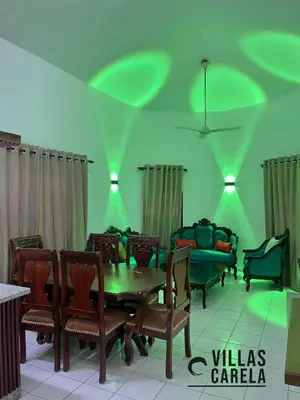 a dining room with a table and chairs and lights at Villas Carela in Cabarete