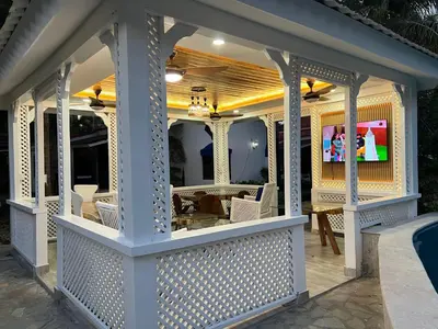a white screened porch with a television on it at Villas Carela in Cabarete