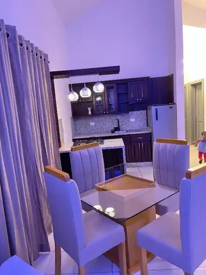 a dining room with a table and chairs and a kitchen at Villas Carela in Cabarete