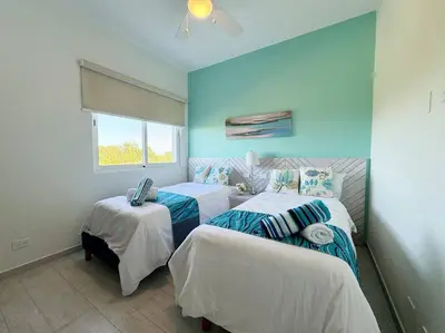 a bedroom with two beds and a window at Cana Pearl Penthouse, Hard Rock Golf & Casino in Punta Cana