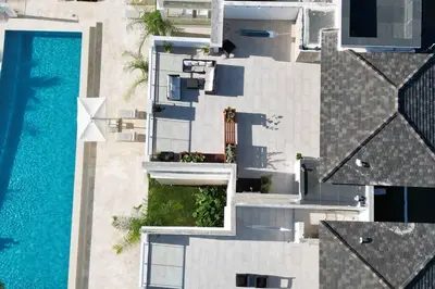 an overhead view of a building and a swimming pool at Cana Pearl Penthouse, Hard Rock Golf & Casino in Punta Cana