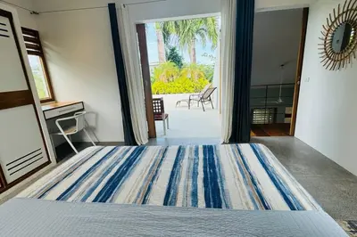 a bedroom with a large bed and a large window at Private Garden Villa With Parking in Las Terrenas