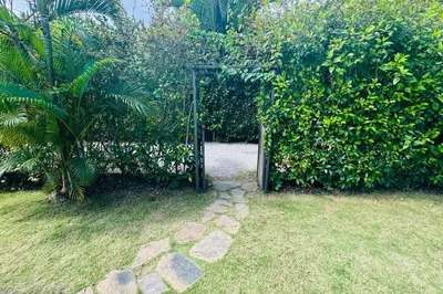 an open gate in a garden with a plant at Private Garden Villa With Parking in Las Terrenas