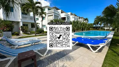 a pair of lounge chairs next to a swimming pool at La Fenice Beachfront 3 Bedroom With Parking in Las Terrenas