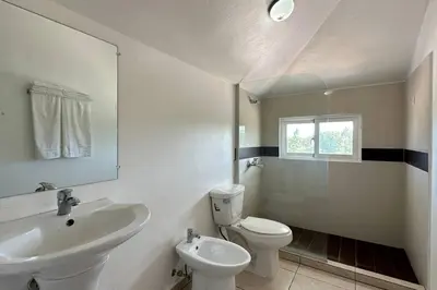 a bathroom with a sink and a toilet and a mirror at La Fenice Beachfront 3 Bedroom With Parking in Las Terrenas