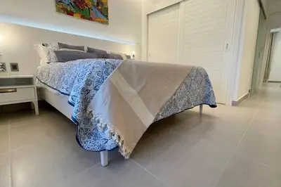 a bedroom with a bed with a blanket on it at Tropical Caribbean space with 2 bedrooms C3 in Punta Cana