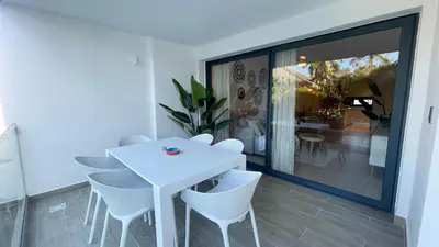 a white dining room with a white table and chairs at Tropical Caribbean space with 2 bedrooms C3 in Punta Cana