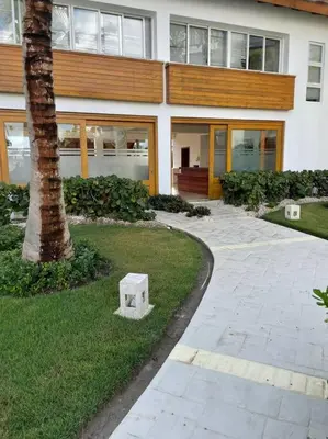 a building with a tree in front of it at beautiful beachfront complex with 2 pools, free wifi, free beach chairs in Punta Cana