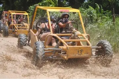 a group of people riding on an off road vehicle at beautiful beachfront complex with 2 pools, free wifi, free beach chairs in Punta Cana