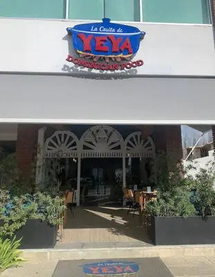 a restaurant with a sign on the front of a building at beautiful beachfront complex with 2 pools, free wifi, free beach chairs in Punta Cana