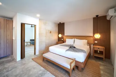 a bedroom with a large bed and a room with a hallway at Empyrean Tropical Wellness Portillo in Las Terrenas