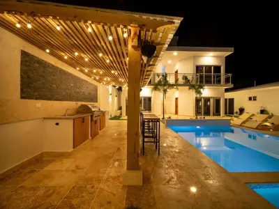 a kitchen and a swimming pool with a house at Green Palace - 7br Luxury Villa in Sosua 3mins from strip plus 24hr security in Sosúa