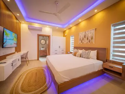 a bedroom with a large bed with a ceiling at Green Palace - 7br Luxury Villa in Sosua 3mins from strip plus 24hr security in Sosúa
