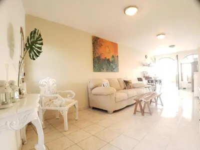a living room with a couch and a table at Immaculate 1-Bed Apartment in Cofresi in Las Flores