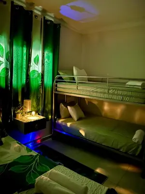 a bedroom with two bunk beds with green curtains at Hotel Mi Dulce Amanecer PyR in Nagua