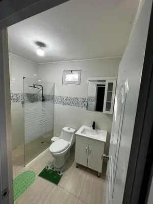 a bathroom with a toilet and a sink and a shower at Hotel Mi Dulce Amanecer PyR in Nagua