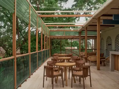 a row of tables and chairs on a patio at Kimpton Las Mercedes by IHG in Santo Domingo
