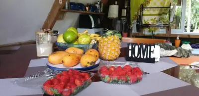 a table topped with bowls of fruit on a table at Canada House Queen bed in 2nd floor dbl sofa bed in 1st floor BBQ Private pool, river in Jarabacoa
