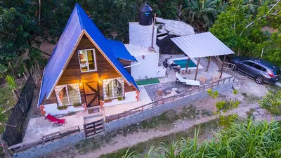 an overhead view of a small house with a blue roof at Canada House Queen bed in 2nd floor dbl sofa bed in 1st floor BBQ Private pool, river in Jarabacoa