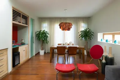 a dining room with a table and red chairs at Billini Hotel, Historic Luxury in Santo Domingo