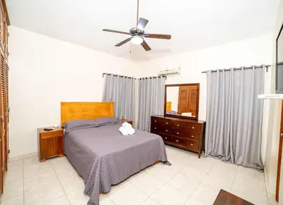 a bedroom with a bed and a ceiling fan at Luxe Comfort 8 Bedroom Villa with Private Pool & Entertainment in Sosúa
