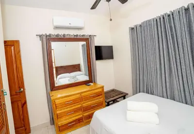 a bedroom with a mirror and a bed and a dresser at Luxe Comfort 8 Bedroom Villa with Private Pool & Entertainment in Sosúa