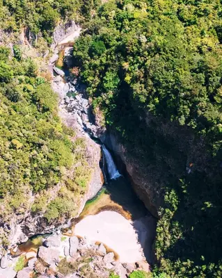 an aerial view of a river in a forest at NOMAD Domes Sky Watching at Jarabacoa in Jarabacoa