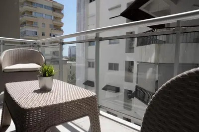 a balcony with a table and chairs on a balcony at Torre Opus 31 - Apto.605 in Santo Domingo
