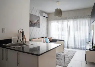 a kitchen with a sink and a living room at Torre Opus 31 - Apto.605 in Santo Domingo
