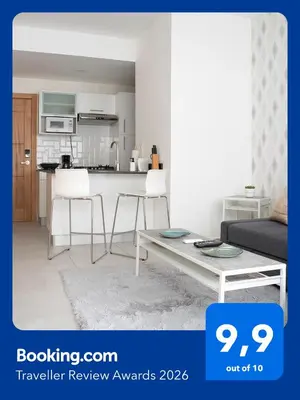 a kitchen and a living room with a table and chairs at Torre Opus 31 - Apto.605 in Santo Domingo