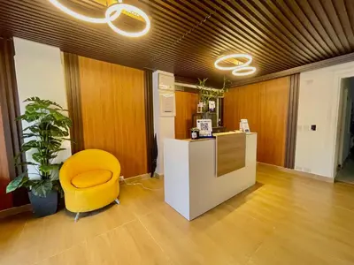 an office with a yellow chair and a desk at RIG Puerto Malecón in Santo Domingo