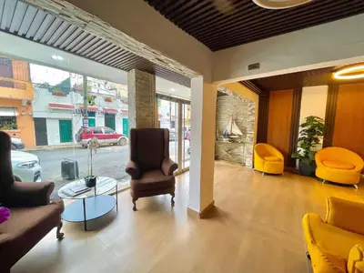 a living room with a couch and chairs and a table at RIG Puerto Malecón in Santo Domingo