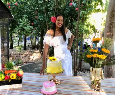 a woman in a white dress standing next to a cake at Hotel Villa Marchena in Azua de Compostela