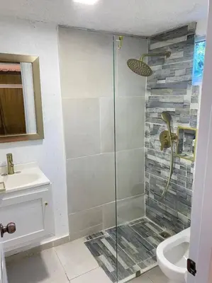a bathroom with a shower and a toilet and a sink at Blessed house 