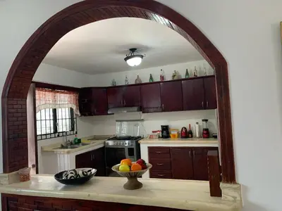 a kitchen with a bowl of fruit on a counter at Residencia Katya in La Romana