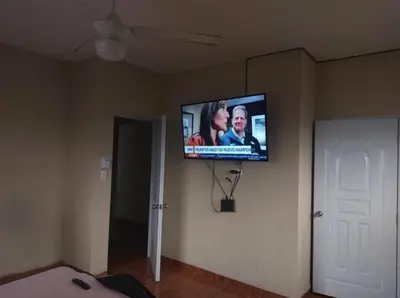 a flat screen tv on a wall in a room at New apartment close to everything in Santiago de los Caballeros