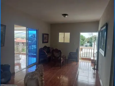 a living room with a couch and chairs and a balcony at New apartment close to everything in Santiago de los Caballeros