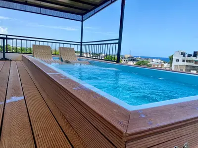 a swimming pool on a balcony with two chairs at RIG Colonial Experience in Santo Domingo