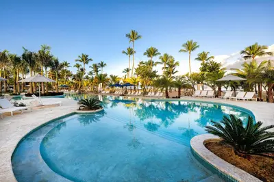 a swimming pool at a resort with palm trees at Viva Miches by Wyndham, a Trademark All Inclusive Resort in Miches