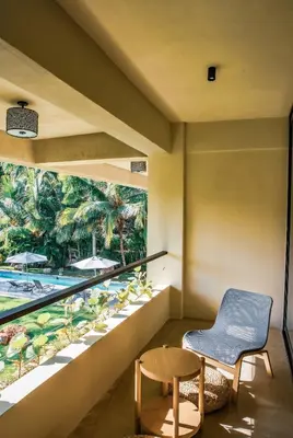 a room with a balcony with a view of the pool at Casa Ataraxia Modern Luxe Villa in Las Terrenas