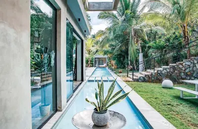 a pool in a house with a potted plant at Casa Ataraxia Modern Luxe Villa in Las Terrenas