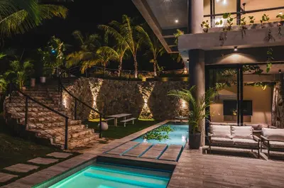 a house with a swimming pool at night at Casa Ataraxia Modern Luxe Villa in Las Terrenas