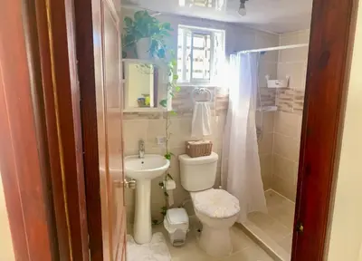 a small bathroom with a toilet and a sink at Acogedor apartamento amueblado in Los Paredones