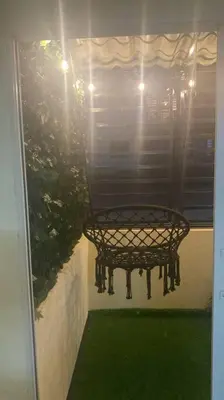 a bench sitting on the porch of a house at Acogedor apartamento amueblado in Los Paredones