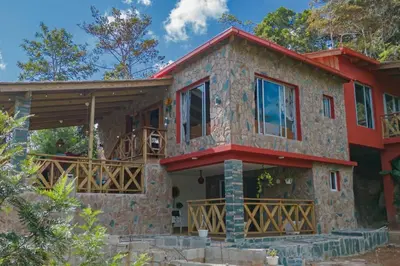 a stone house with a red roof at Villa Tortuga Constanza in Constanza