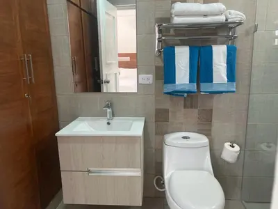 a bathroom with a toilet and a sink and a mirror at Luxury Beach Front Villa with Private pool and stunning Ocean View! in Punta Rucia