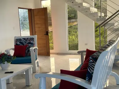 a living room with two chairs and a table at Luxury Beach Front Villa with Private pool and stunning Ocean View! in Punta Rucia